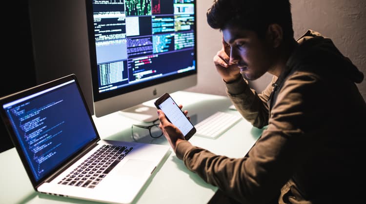 programmer looking at code on phone