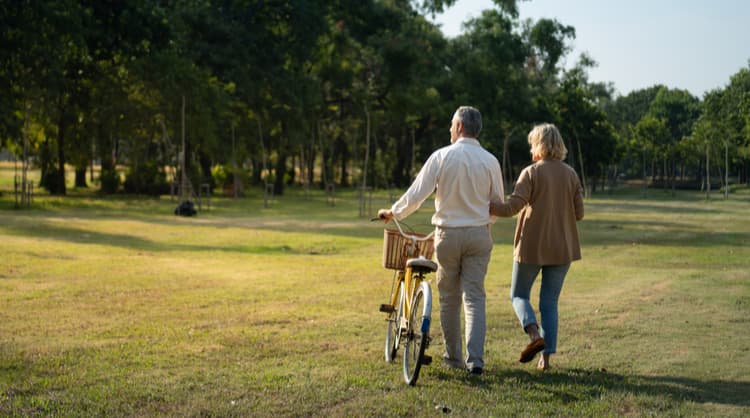 elderly couple working across park