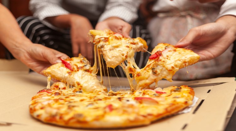 colleagues having pizza together