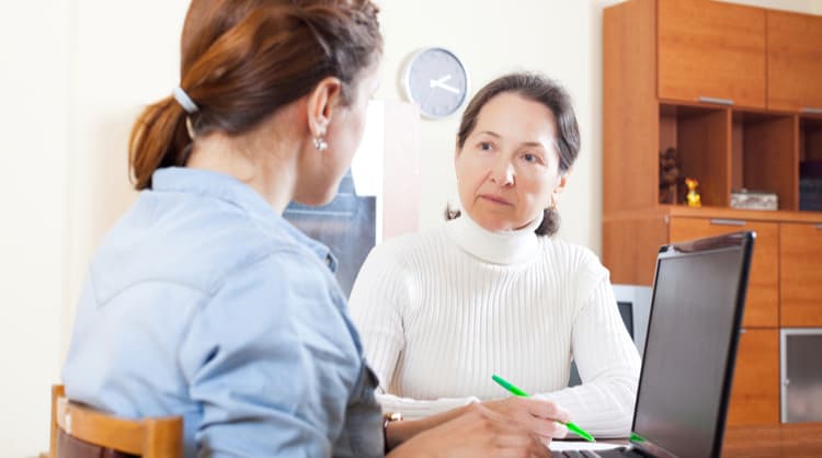 woman case manager talking to elderly woman client