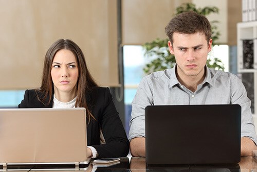 colleagues side by side looking at each in disgrace