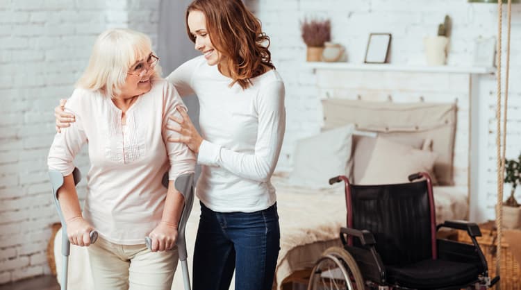 carer assisting elderly patient