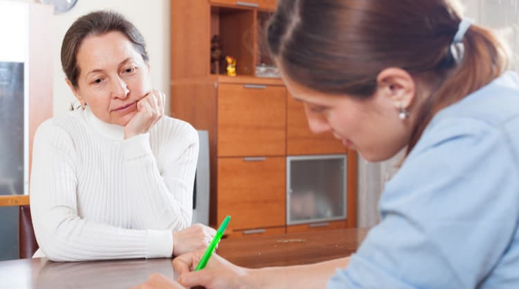 case manager asking questions to older woman