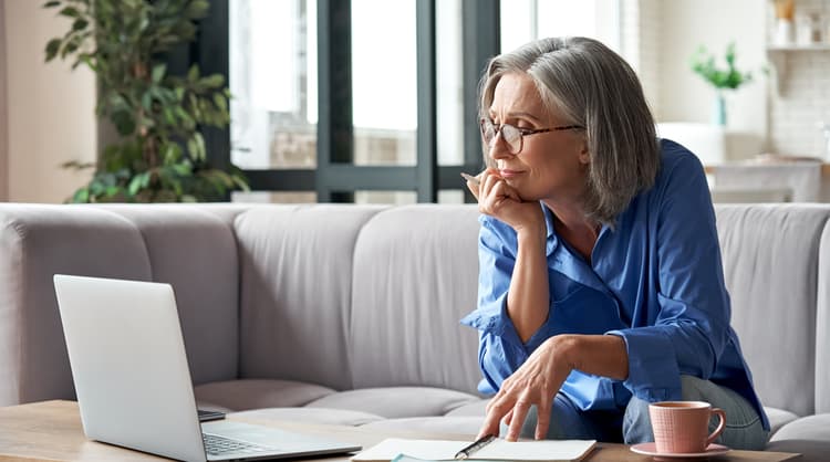 older woman doing research on laptop