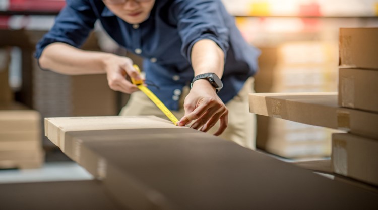 asian man measuring flatpack