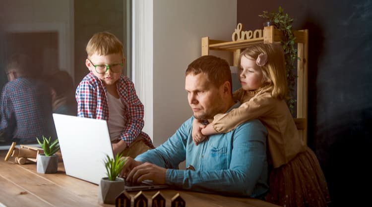 man working from home with children nearby