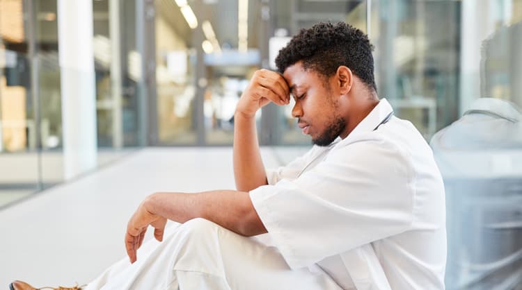 man sitting on floor burnt out