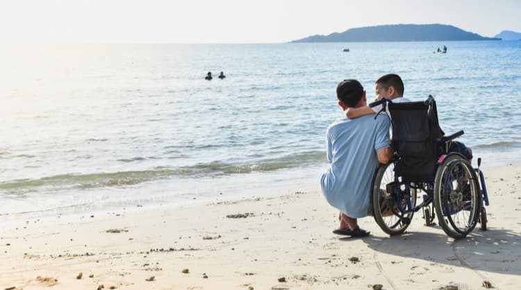 boy in wheelchair at the beach