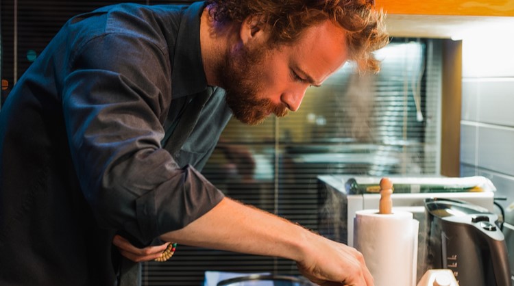 bearded man cooking dinner