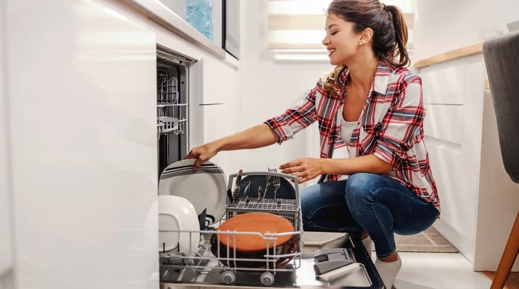 woman unloading dishwasher