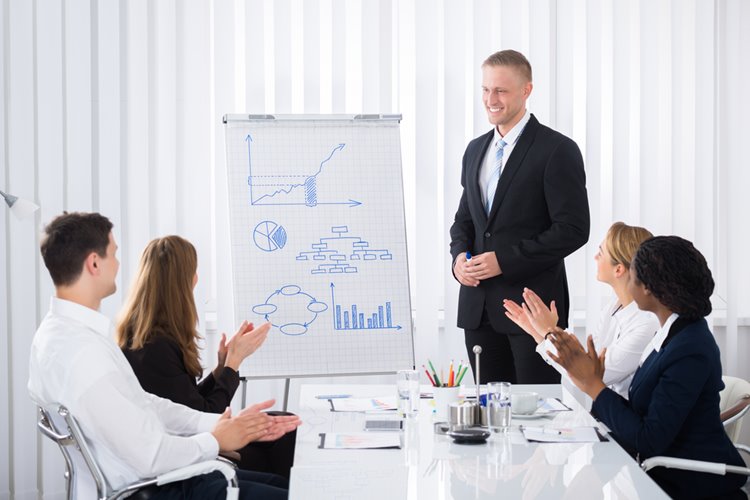 work colleagues clapping after presentation