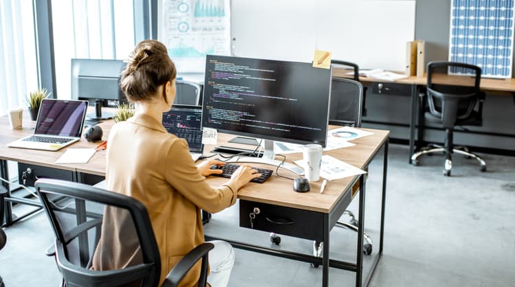 young woman programmer working at the office