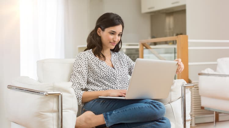 young woman researching on laptop