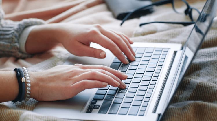 woman typing on laptop