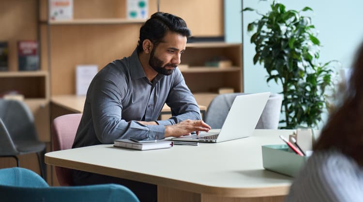 man working on laptop fully concentrated