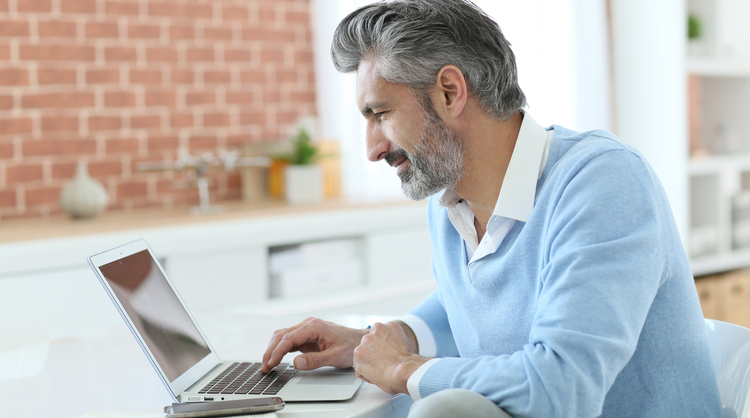 older man working from home