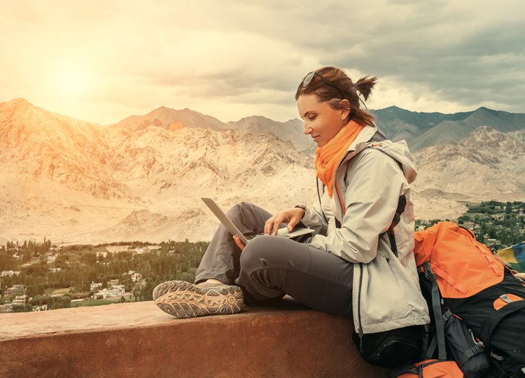 woman travel journalist working on laptop