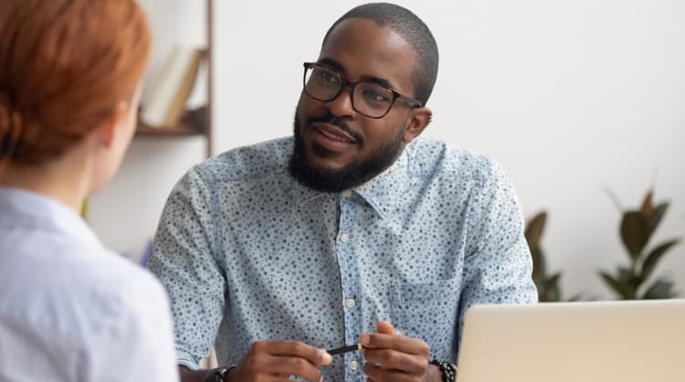 male boss listening to employee, in a one-on-one meeting