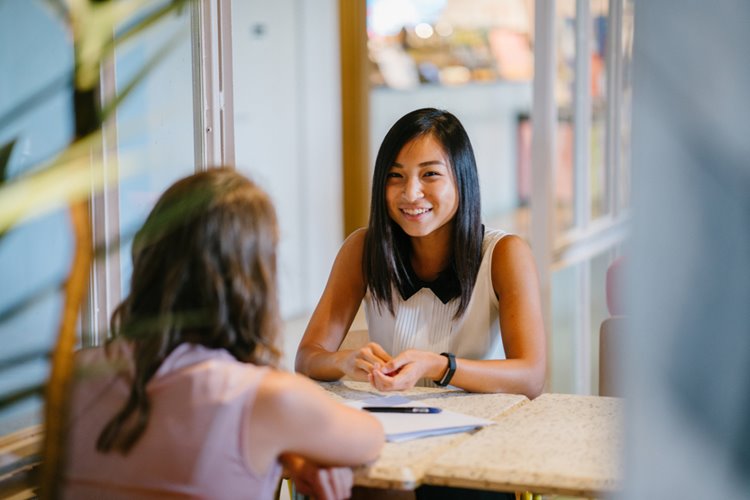 young asian woman meeting someone in interview