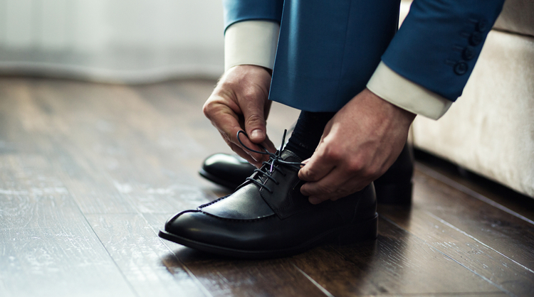 business man tying shoes