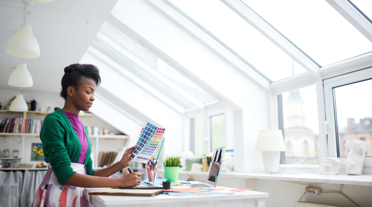 woman designer looking at potential colour schemes