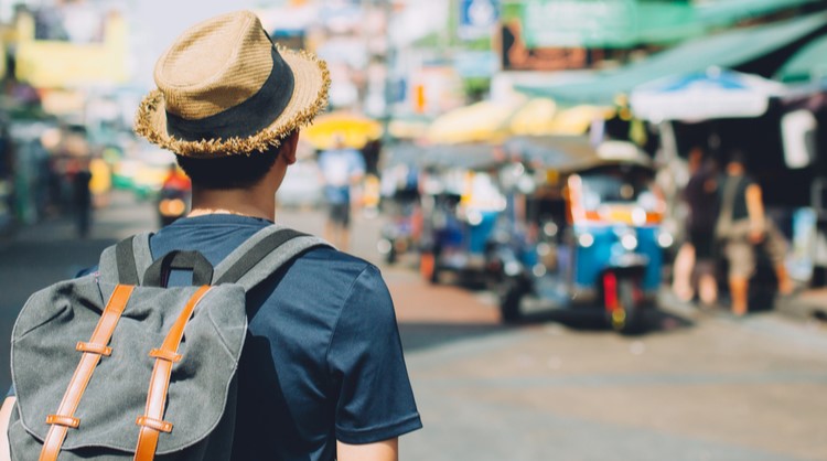 young asian man backpacking trip somewhere in asia