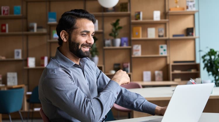 man smiling at laptop