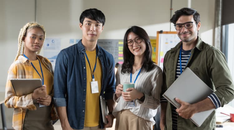 employees facing the camera and smiling