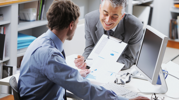 two male employees talking to each other