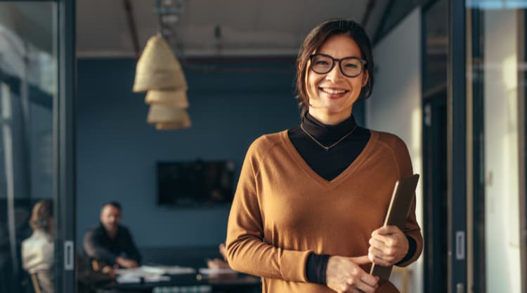 confident woman holding laptop