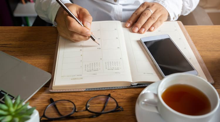 man writing in diary