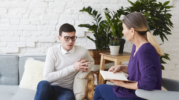 young man speaking to counsellor