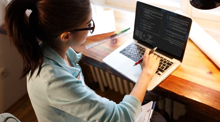 woman programmer working on laptop