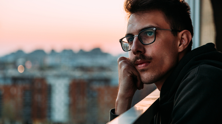 man with glasses thinking