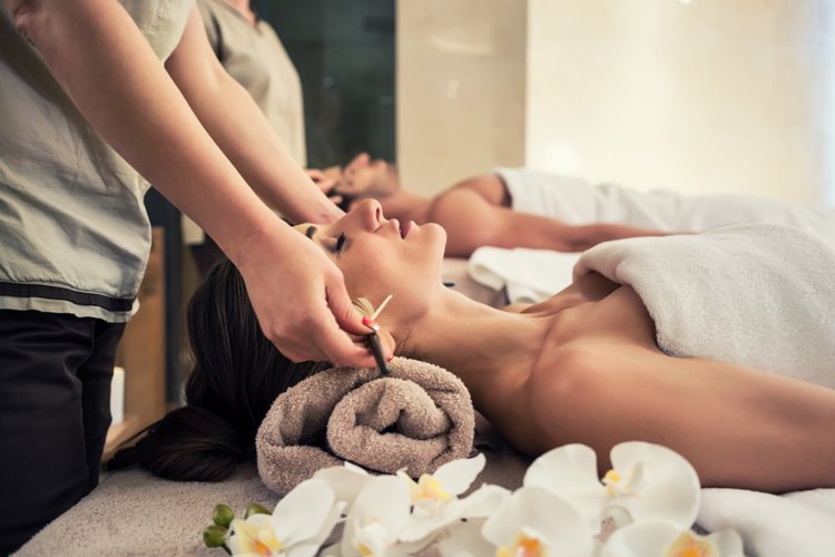 beauty therapist massaging client's head