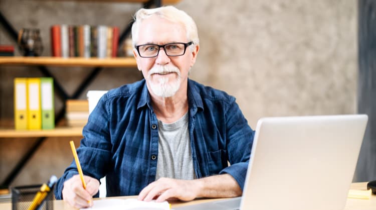 older man studying online