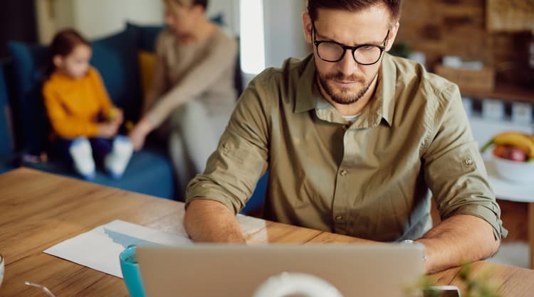 man looking at laptop screen intently