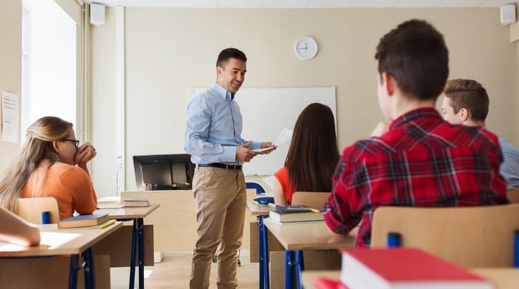 male teacher speaking to high school students