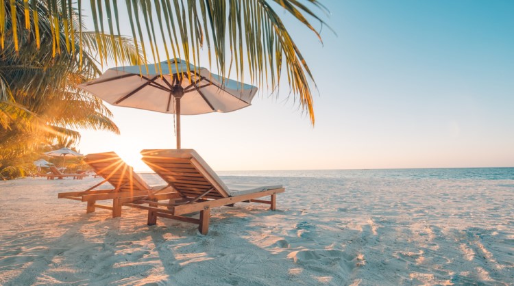 beach setting with umbrella and chairs