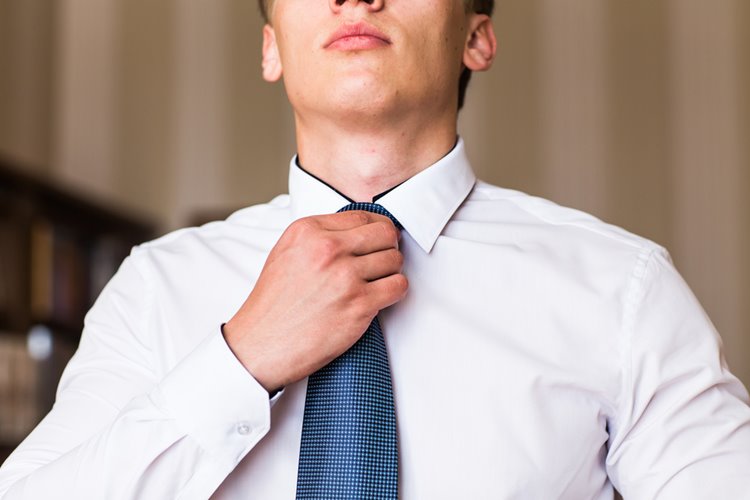 young man fixing up tie