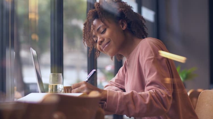 african american woman smiling while studying