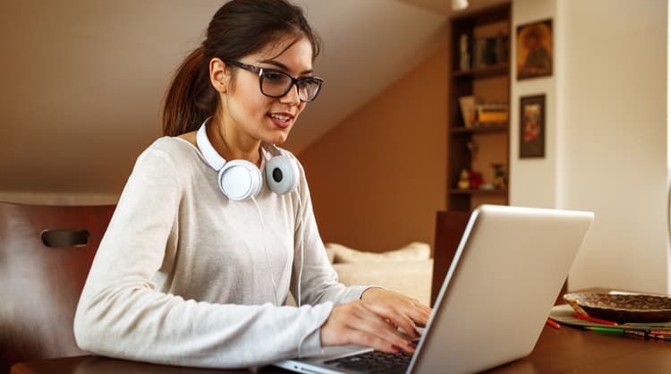 young woman typing on laptop