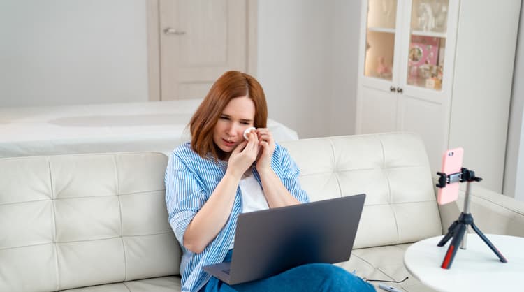 young woman getting emotional while counselling online