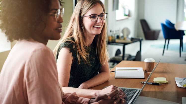 two women working together