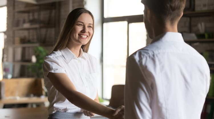 woman shaking man's hand