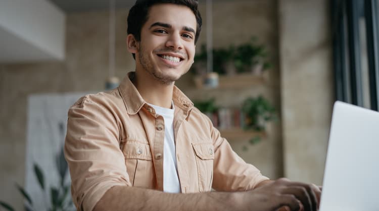 smiling male student studying online