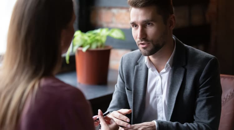 man talking with woman looking serious