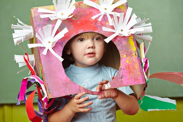 little boy in cardboard box costume