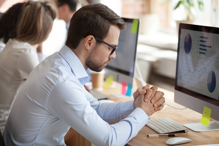 male employee trying to keep calm under pressure from work