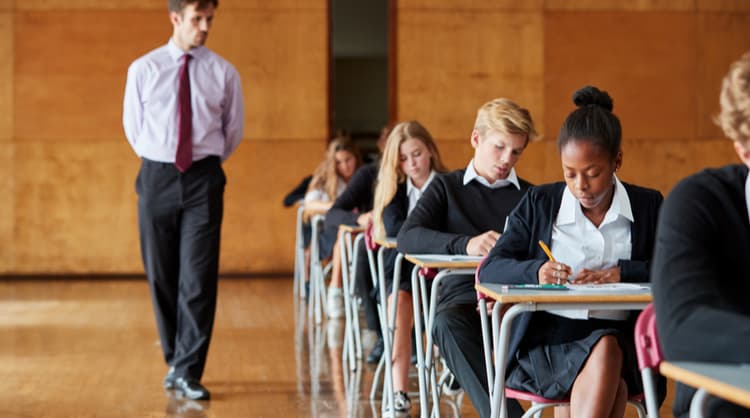 teenage students undertaking exams